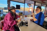 Davanzo sitting at a counter opposite the diner owner