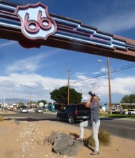 Davanzo taking a photograph of large overhead "66" sign