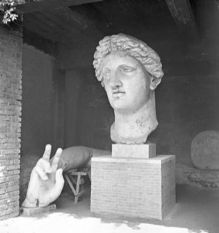 Nash’s photograph shows fragments of a colossal cult statue—female head, arm, and gesturing hand-from the Sacred Area of Largo Argentina in Rome, which has three Republican temples.