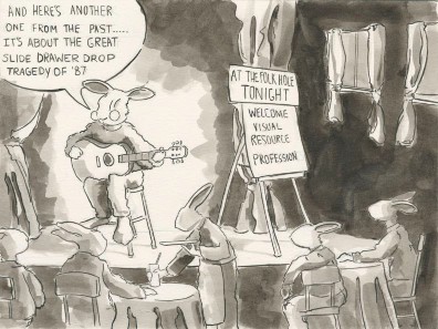 A rabbit folksinger addresses a crowd of visual resource librarians attending small concert at the Folk Hole, telling them the next song will be about the drawer drop of ’87